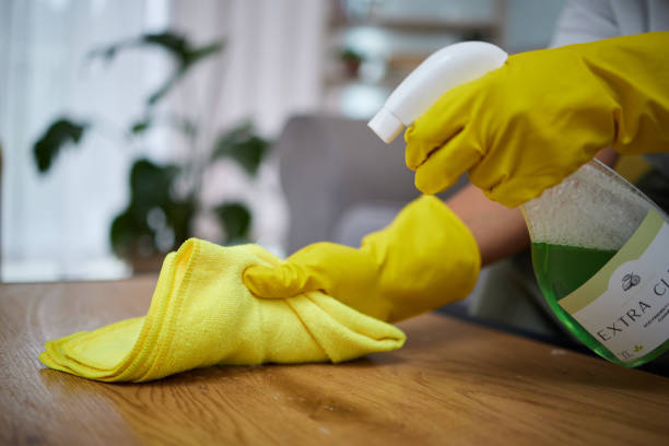 office table cleaning with cloth and sanitizer