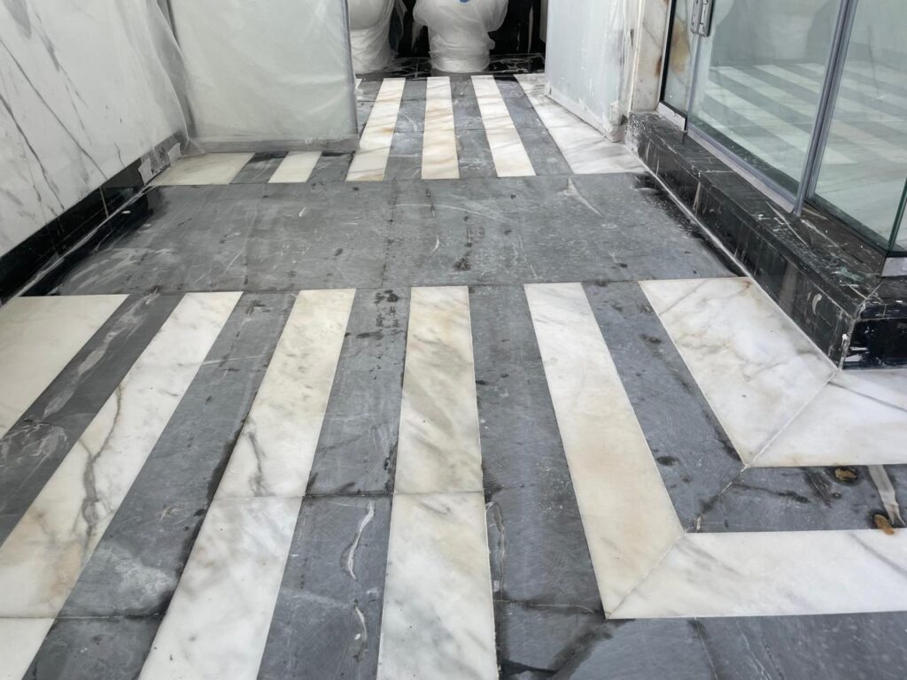 Black marble floor before restoration in Hattan Villa bathroom – dull surface needing marble floor maintenance Dubai