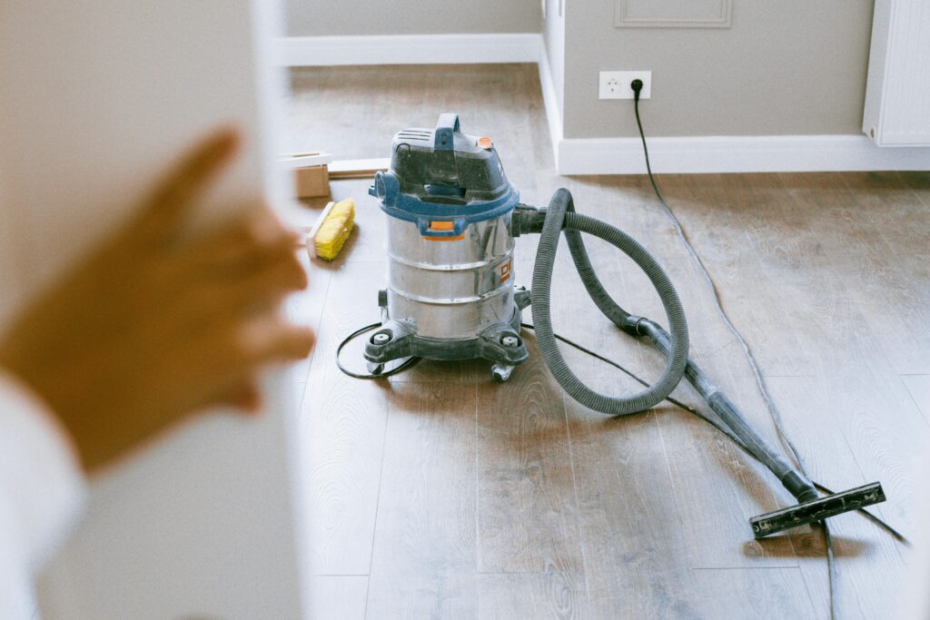 Vacuum machine cleaning dust and debris in a newly constructed room in Dubai Hills.