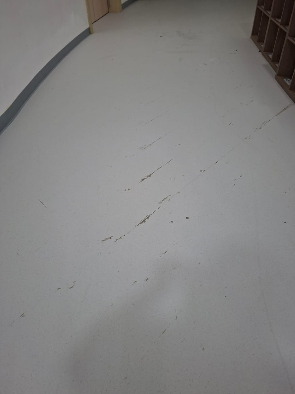 Before vinyl floor cleaning — scratches, glue and dull surface in Dubai school
