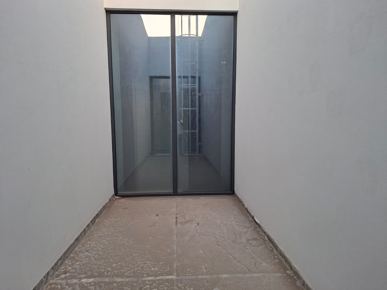 Outdoor porcelain tiles with cement spots before cleaning